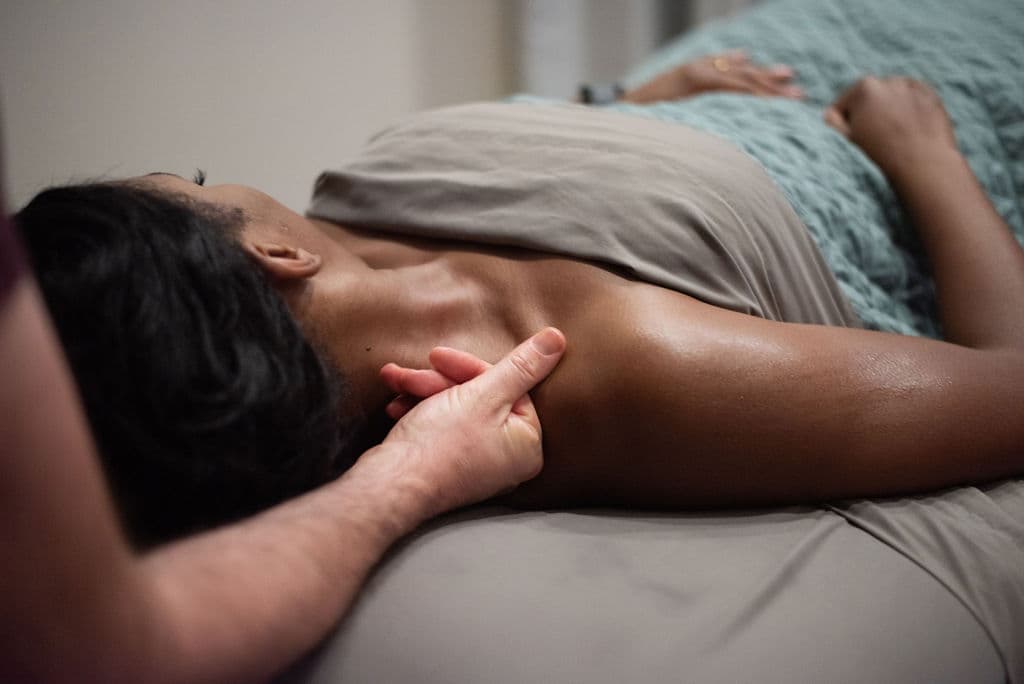 A massage therapist working with a client